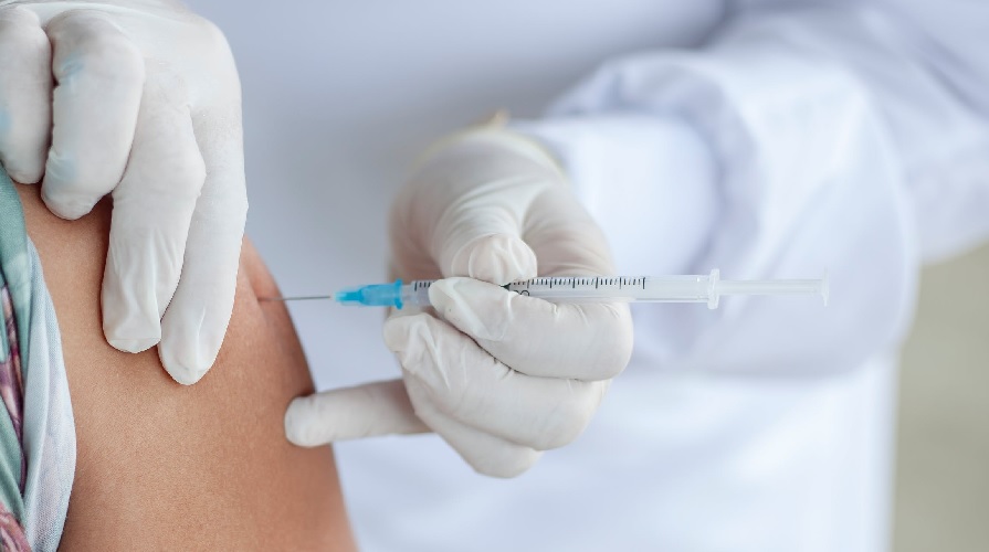 En arm blir injicerad med vaccin.